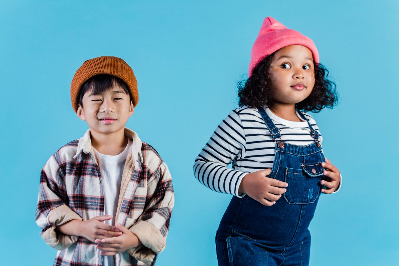quality-assurance-01 Multiethnic kids in casual clothes standing on blue background and making grimace in room